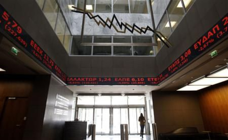 Stock prices are displayed inside the Stock Exchange in Athens