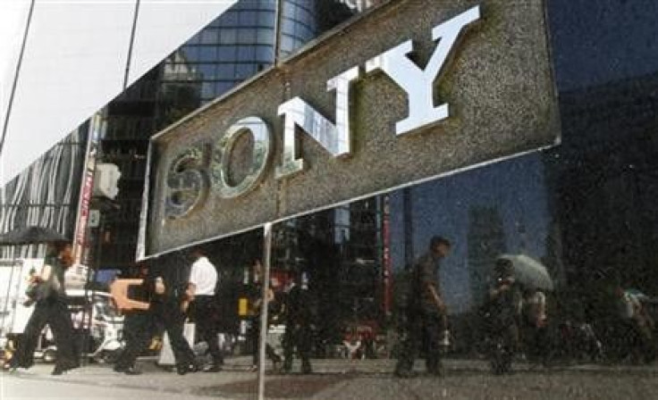 Pedestrians are reflected on a Sony signage in Tokyo