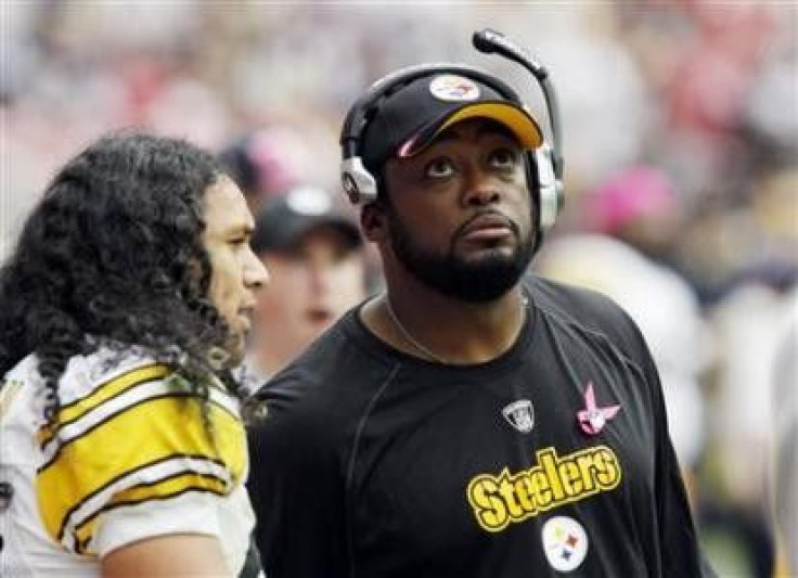 Pittsburgh Steelers coach Mike Tomlin looks at the scoreboard as he talks with safety Troy Polamalu Polamalu during their NFL game in Houston in this October 2, 2011 file photo After a crushing loss to the Baltimore Ravens on the opening day of the 2011 s