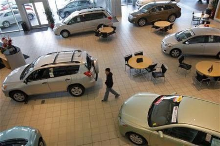 A customer looks over Toyota automobiles at a dealership in Daly City, California