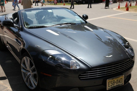 An Aston Martin parked outside of the gate at the Saratoga Race Course on opening weekend.