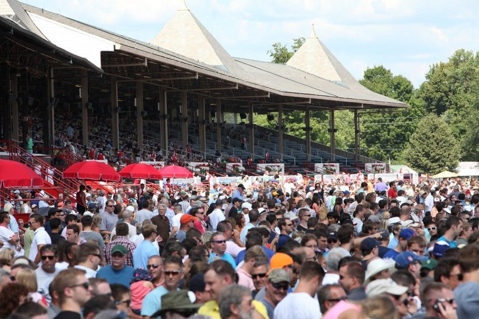 The crowd gathered by the track for the races at the Saratoga Race Course on opening weekend.