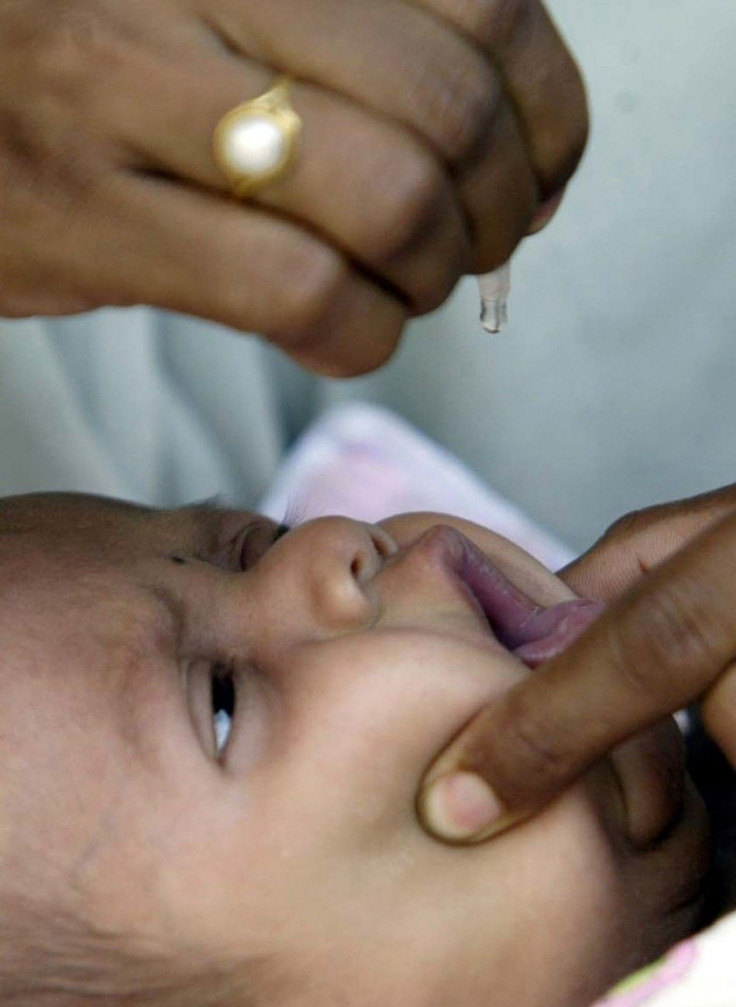 A child receives polio drops at a polio booth in Bhopal