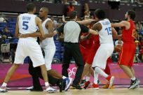 Officials try to separate the players of Spain and France after a hard foul by France&#039;s Batum during their men&#039;s quarterfinal basketball match