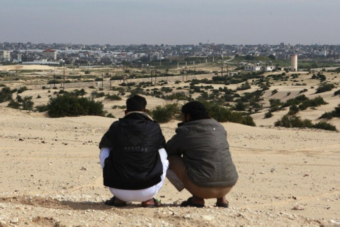 Bedouins squat over a hilly area overlooking Gaza, in Rafah city, north Sinai,