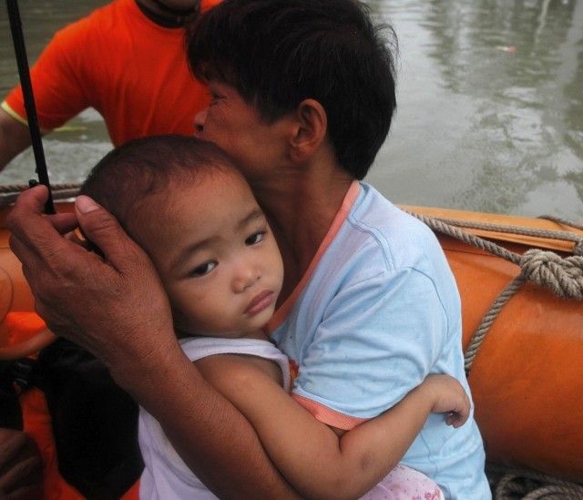 Woman and Child Being Rescued