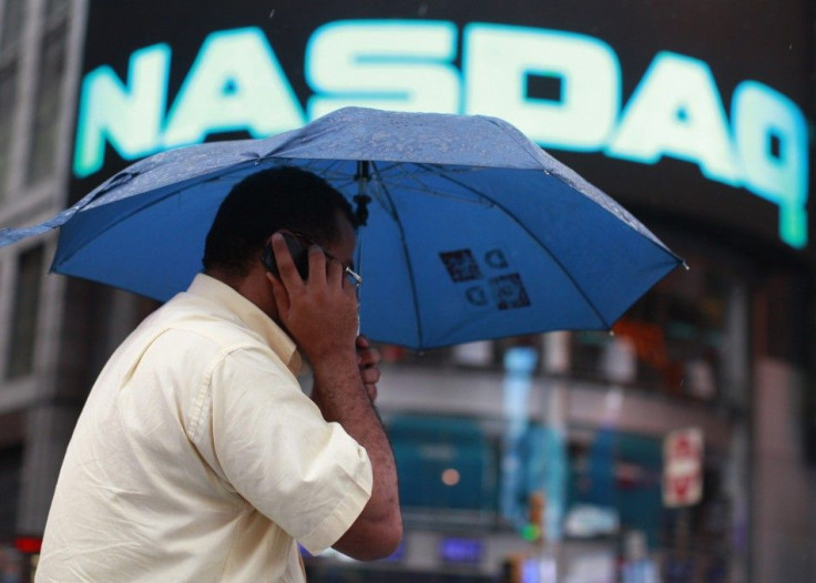 A man takes a photo outside the Nasdaq Market site in New York&#039;s Times Square