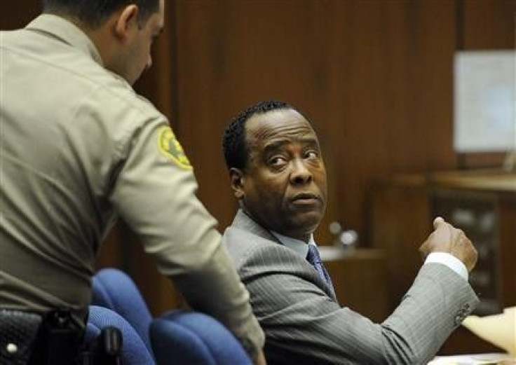 Dr. Conrad Murray speaks with a Los Angeles County Sheriff&#039;s Deputy in the courtroom during his trial in the death of pop star Michael Jackson in Los Angeles