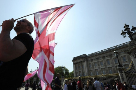 A demonstrator carries a pink Union flag outside Buckingham Palace during a protest against Britain&#039;s gay marriage ban, in London
