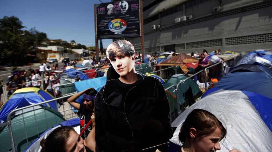 Fans hold a cardboard cut-out of Canadian pop singer Justin Bieber