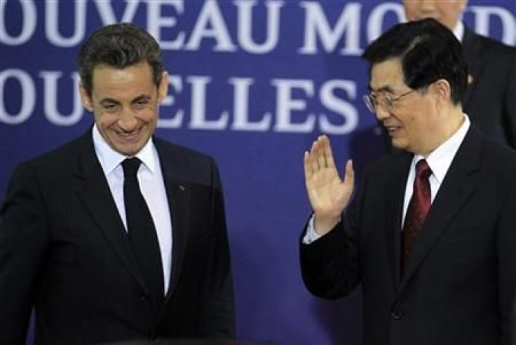 China&#039;s President Hu Jintao waves beside France&#039;s President Sarkozy as they at the G20 venue where world leaders gather in Cannes