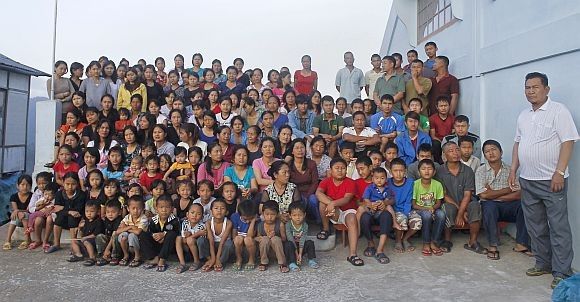 Family members of Ziona R poses for group photograph outside their residence in Baktawng village in the northeastern Indian state of Mizoram, October 7, 2011