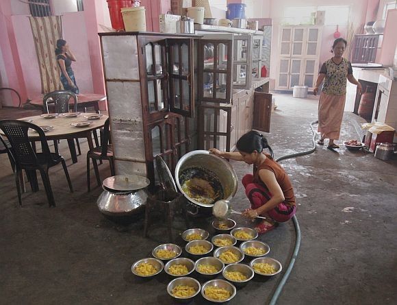 A wife of Ziona prepares breakfast at their residence