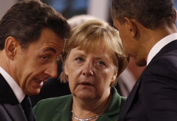 U.S. President Barack Obama, talks to Germany&#039;s Chancellor Angela Merkel, and France&#039;s President Nicolas Sarkozy before the start of the G20 Summit of major world economies in Cannes