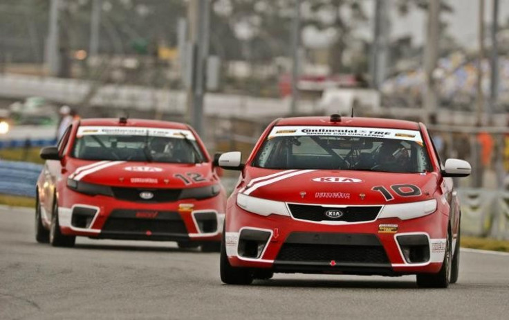 Two of Kia&#039;s Forte Koup racecars piloted by Kinetic Motorsports on the track.
