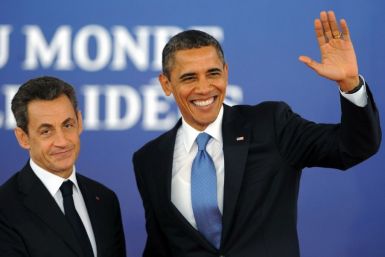 U.S. President Barack Obama waves as he is greeted by France's President Nicolas Sarkozy before the start of the G20 Summit of major world economies in Cannes