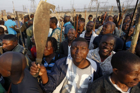 Protesters striking at a platinum mine in South Africa Thursday. Many in the crowd were armed.