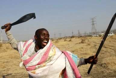 A protester striking at a platinum mine in South Africa Thursday. Many in the crowd were armed.