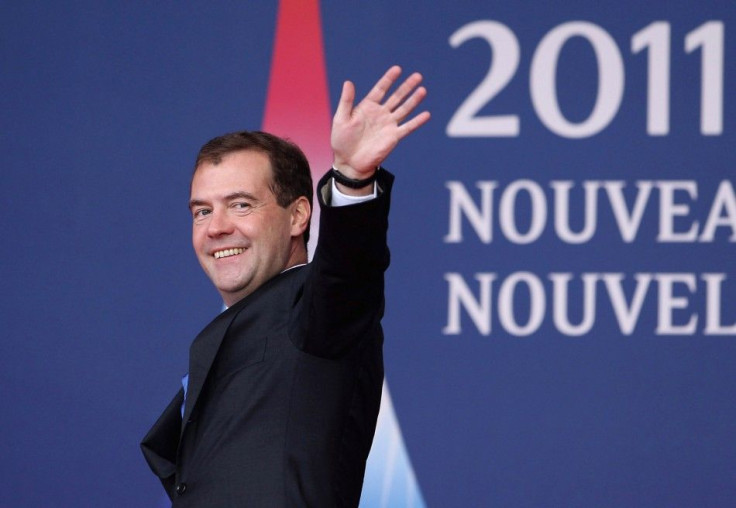 Russia's President Dmitry Medvedev waves as he arrives for the G20 Summit of major world economies in Cannes