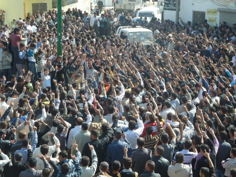 Anti-government protesters shout slogans against Syria039s President Bashar al-Assad during the funeral of Sunni Muslim villagers killed on Wednesday, in Hula near Homs November 2, 2011