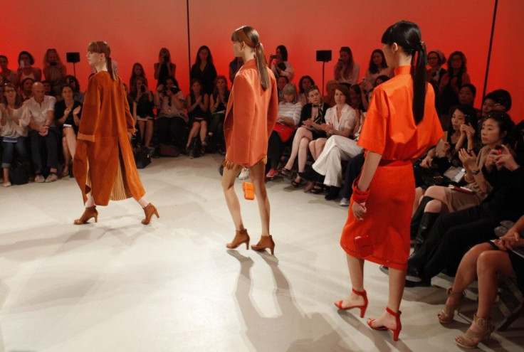 Models appear at the end of a presentation by French designer Christophe Lemaire for fashion house Hermes as part of their Spring/Summer 2012 fashion collection in Paris