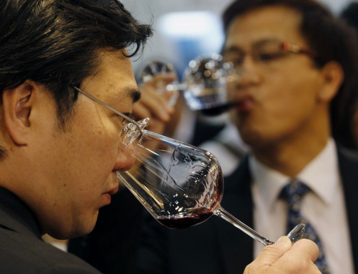 Visitors examine wine Vinexpo Asia-Pacific held at the Hong Kong Convention and Exhibition Centre