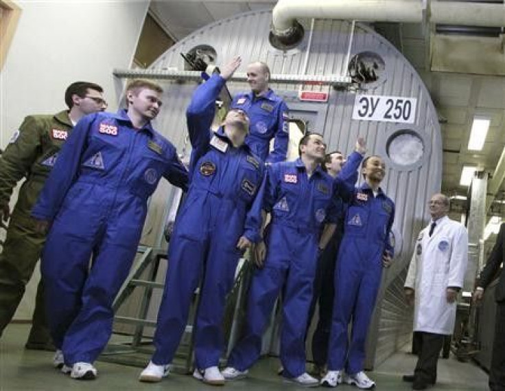 Mars500 experiment crew members react after leaving the mock spaceship in Moscow