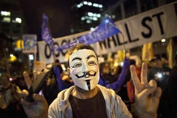 An Occupy Wall Street protestor wearing a Guy Fawkes mask takes part in the 39th Annual Halloween Parade in New York
