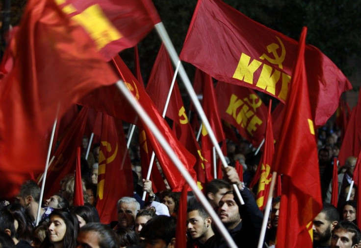 Supporters of Greece&#039;s Communist Party wave flags as they demonstrate in Athens&#039; Syntagma square.
