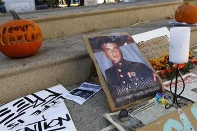Signs and pumpkins are displayed for former U.S. Marine Scott Olsen, who was injured in last week&#039;s Occupy Oakland protests, near Frank Ogawa Plaza in Oakland, California