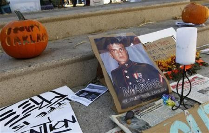 Signs and pumpkins are displayed for former U.S. Marine Scott Olsen, who was injured in last week&#039;s Occupy Oakland protests, near Frank Ogawa Plaza in Oakland, California