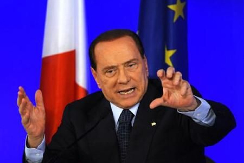 Italy's Prime Minister Berlusconi gestures during a news conference at the end of the G20 Summit in Cannes