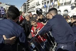 Greeks scuffle with policemen as they protest against austerity policies during a students parade in Athens