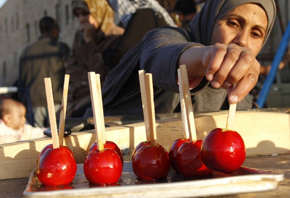 A street vendor arranges apples dipped in a syrup during the first day of Eid al-Adha, at the port-city of Sidon, southern Lebanon, November 6, 2011.