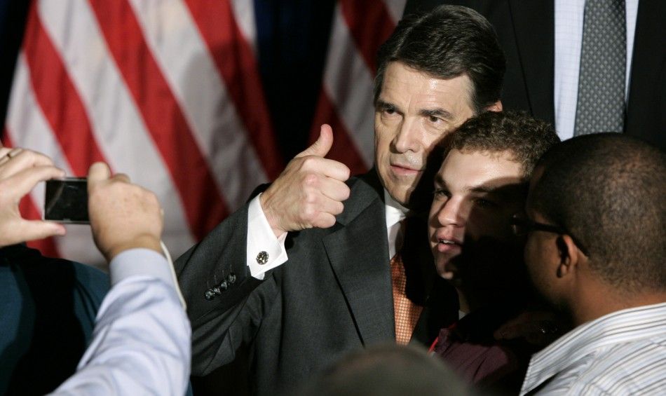 Texas Governor Rick Perry poses for pictures with supporters after announcing his presidential bid, in Charleston, South Carolina, August 13, 2011. 