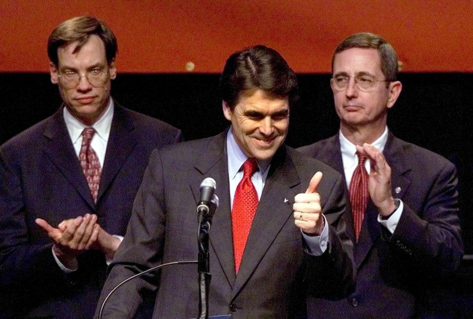 Texas Republican Governor Rick Perry C gives thumbs up to supporters during his victory speech in Austin, Texas, November 5, 2002. 