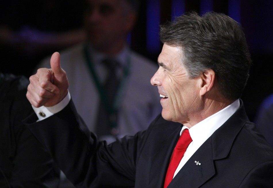 Republican presidential hopefuls Texas Gov. Rick Perry gives a thumbs up at the Republican presidential debate at Dartmouth College in Hanover, New Hampshire October 11, 2011.
