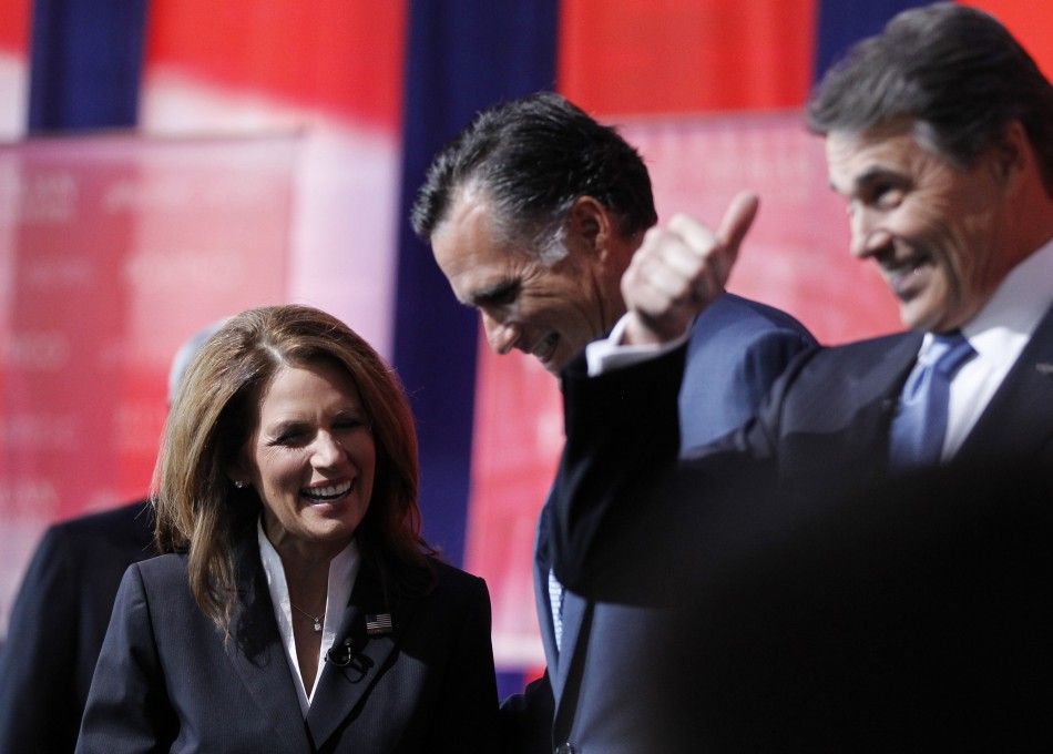 Rep. Michele Bachmann R-MN talks to former Massachusetts Governor Mitt Romney C and Texas Governor Rick Perry R on stage before the Reagan Centennial GOP presidential primary debate at the Ronald Reagan Presidential Library in Simi Valley, Californi