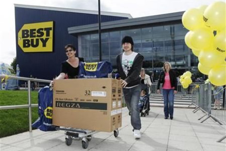 Shoppers push a television from Britain&#039;s first Best Buy store, which the U.S. retailer opened early Friday, in Thurrock