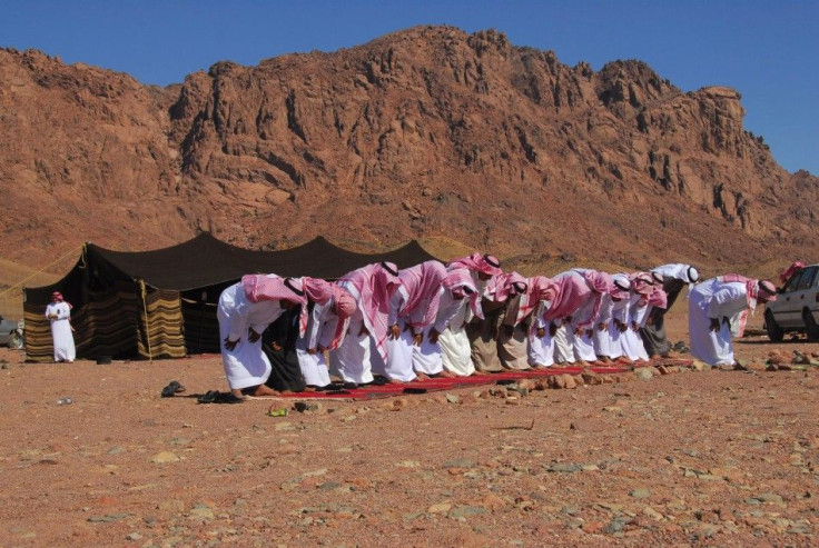 People pray in Ashwaq village on the occasion of Eid al-Adha near the city of Tabuk, Saudi Arabia