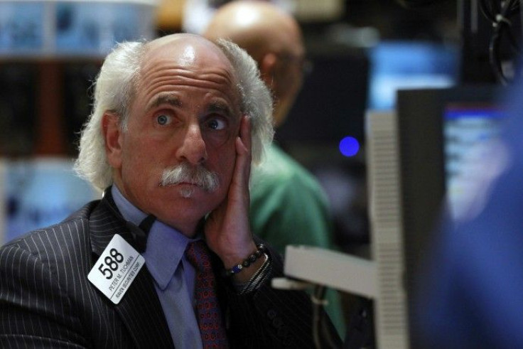 Trader Peter Tuchman looks up at a screen on the floor of the New York Stock Exchange