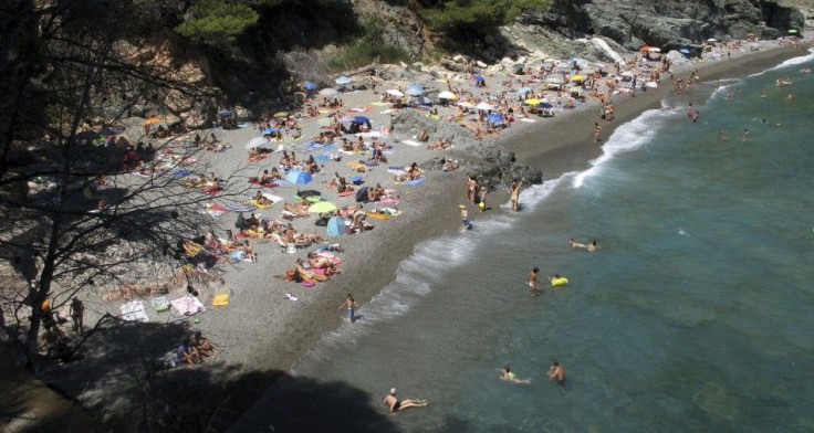 People sunbathe at Fonda beach in Begur, in Catalunya&#039;s Costa Brava, near Girona, Spain, August 9, 2011.
