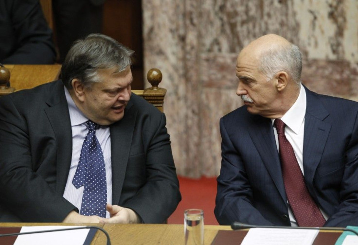 Greek Finance Minister Evangelos Venizelos (L) and Prime Minister George Papandreou talk in the parliament prior to a confidence vote in Athens November 4, 2011.