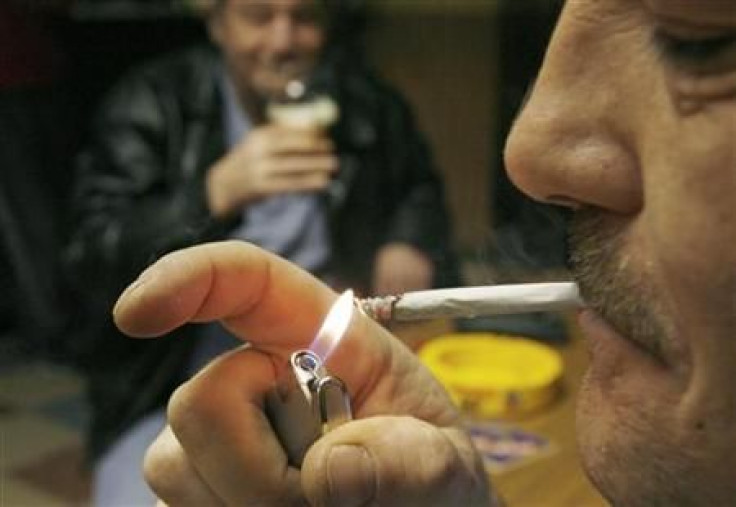 A man lights a cigarette at Brambles Farm working mens club in Middlesbrough