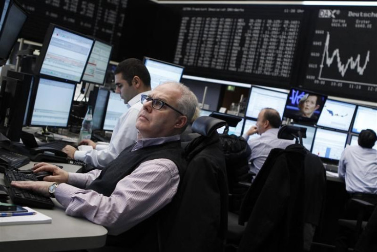 Traders work at their desks at the Frankfurt stock exchange