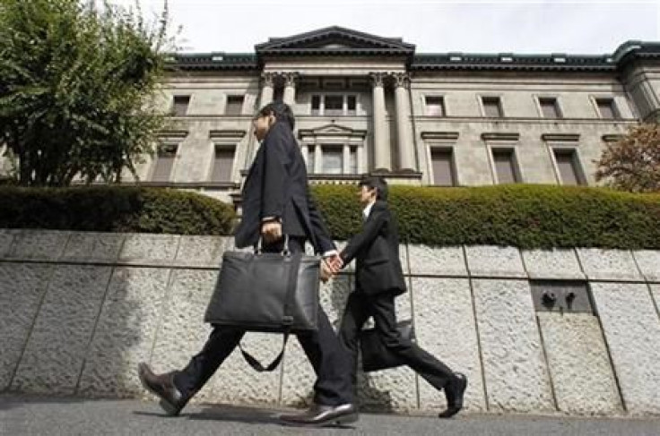 Pedestrians pass by the Bank of Japan building in Tokyo