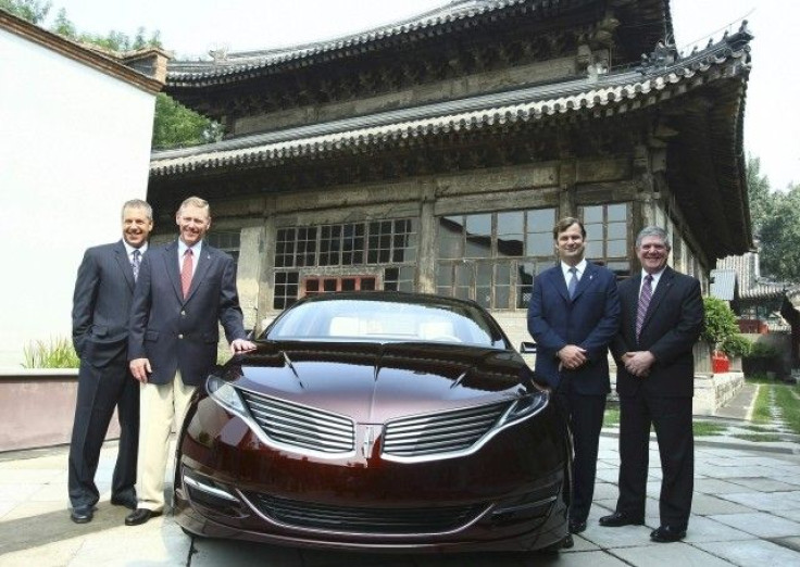 Handout photo shows Ford Motor officials posing with a Lincoln MKZ Concept car in Beijing.