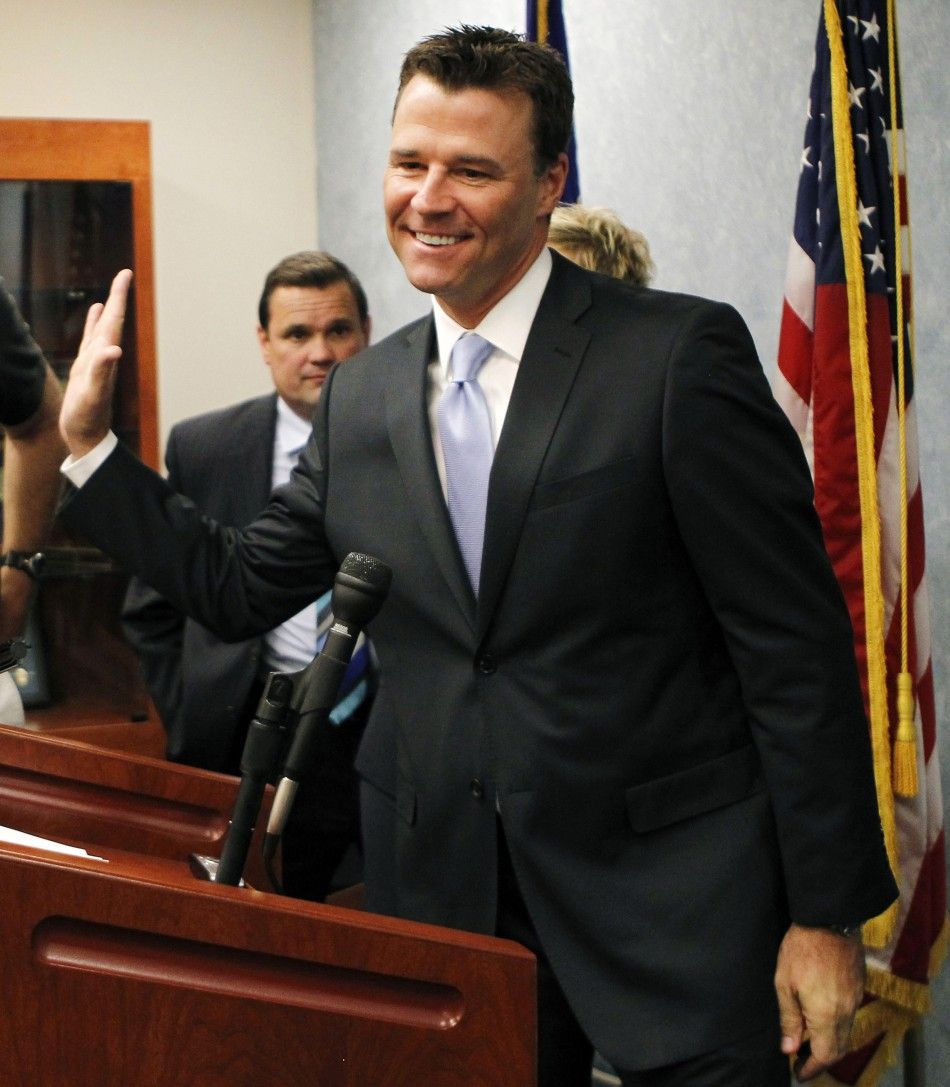 Deputy District Attorney Walgren waves as he leaves a news conference in Los Angeles