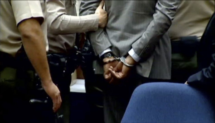 Dr. Conrad Murray is led away in handcuffs in Los Angeles