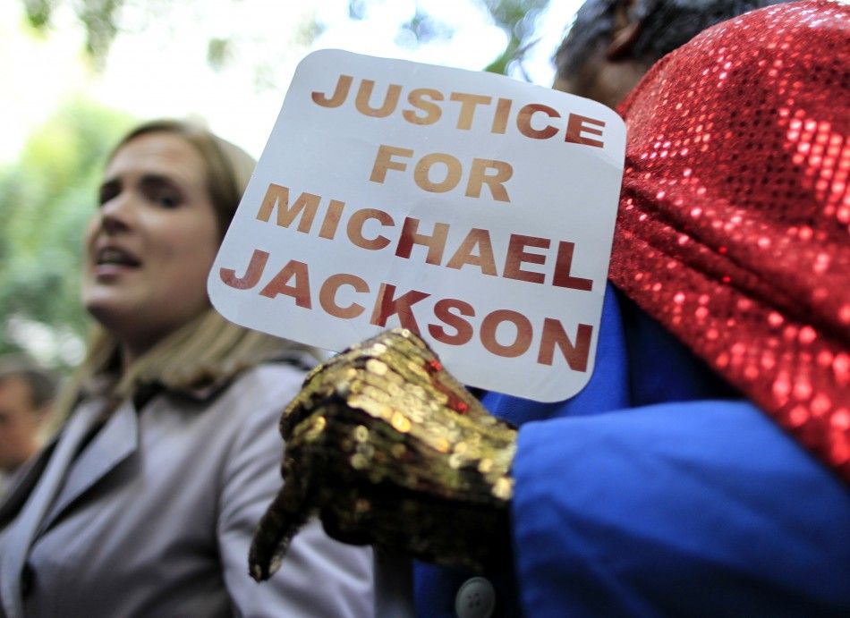 A fan of Michael Jackson holds a sign outside the courthouse after the reading of the guilty verdict in Dr. Conrad Murrays trial in Los Angeles